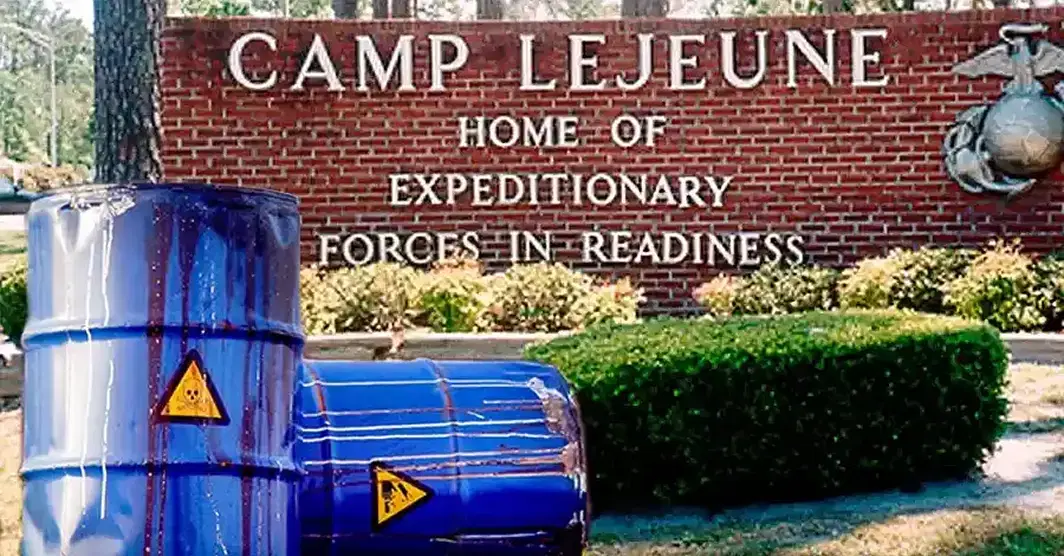 Toxic waste barrels outside the Camp Lejeune base entrance sign